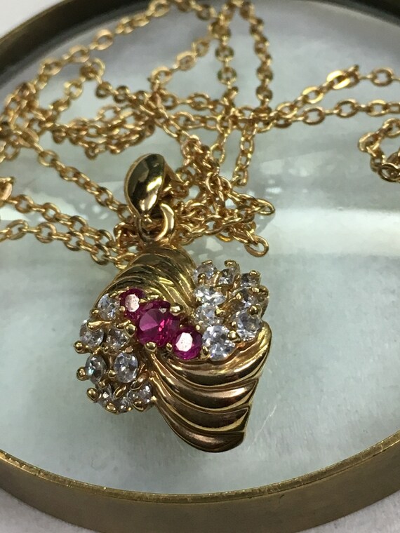 Ruby and Cubic Zirconia in a  swirl of Gold on  a 