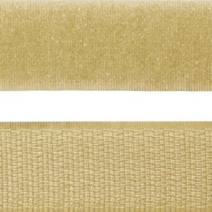 May include: Two strips of beige hook and loop fastener tape. The top strip is a soft, fuzzy loop side. The bottom strip is a rough, textured hook side.