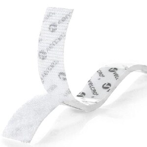 May include: A white adhesive hook and loop fastener strip with a textured surface. The backing paper is white and features the repeating black text and logo for VELCRO. The strip is partially peeled back to reveal the adhesive side and the fastener.