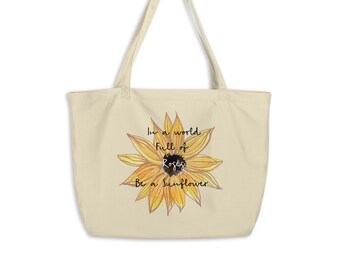 Peut inclure: Un sac fourre-tout beige avec un motif de tournesol et le texte "Dans un monde plein de roses, soyez un tournesol".