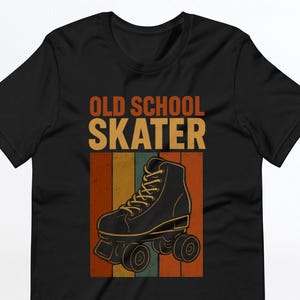 May include: Black t-shirt with the words "OLD SCHOOL SKATER" in orange and tan. A black roller skate is centered below the text, set against a backdrop of vertical stripes in orange, green, and tan.