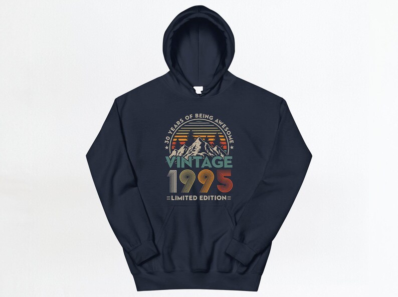 May include: Navy blue hooded sweatshirt with a vintage 1995 design. The graphic features a sunset mountain scene with the text "30 Years of Being Awesome Vintage 1995 Limited Edition".