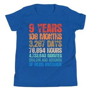 May include: A blue youth t-shirt with a colorful graphic that reads "9 Years 108 Months 3,287 Days 78,894 Hours 4,733,640 Minutes 284,018,400 Seconds of Being Awesome".