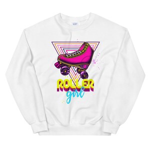 May include: White sweatshirt with a retro design. It features a pink roller skate, a geometric triangle, and the words "ROLLER girl" in yellow and teal. The design has a vintage, neon aesthetic.