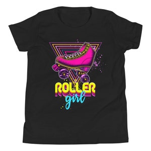 May include: Black t-shirt with a retro design. It features a pink roller skate, a neon triangle, and the words "ROLLER girl" in yellow and blue. The graphic has a vintage, 80s-inspired aesthetic.