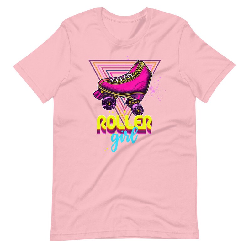 May include: Pale pink t-shirt with a retro roller skate design. The graphic includes a pink roller skate, a triangle, and the words "ROLLER girl" in a vibrant, 80s-style font. A stylish tee for roller skating fans.