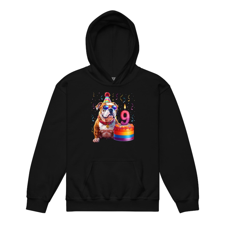 May include: Black hoodie featuring a colorful illustration of a bulldog wearing sunglasses and a party hat. The bulldog is next to a rainbow-colored cake with a lit candle displaying the number 9. Confetti and streamers are in the background.