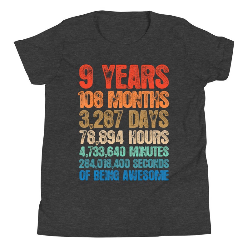 May include: A dark gray youth t-shirt with a colorful graphic that reads "9 Years 108 Months 3,287 Days 78,894 Hours 4,733,640 Minutes 284,018,400 Seconds of Being Awesome".