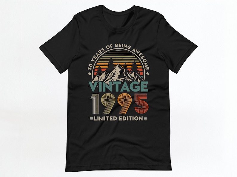 May include: Black t-shirt with a vintage 1995 design. The design features a mountain range with a sunset behind it and the text "30 Years of Being Awesome Vintage 1995 Limited Edition".