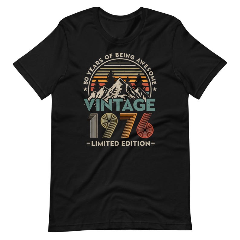 May include: Black t-shirt with a vintage design celebrating a 50th birthday. The graphic includes mountains, trees, and the text "50 Years of Being Awesome" and "Vintage 1976 Limited Edition" in retro colors.