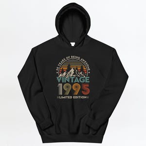 May include: Black hooded sweatshirt with a vintage 1995 design. The graphic features a sunset scene with mountains and the text "30 Years of Being Awesome Vintage 1995 Limited Edition".