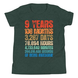 May include: A green t-shirt with a colorful graphic that reads "9 Years 108 Months 3,287 Days 78,894 Hours 4,733,640 Minutes 284,018,400 Seconds of Being Awesome".