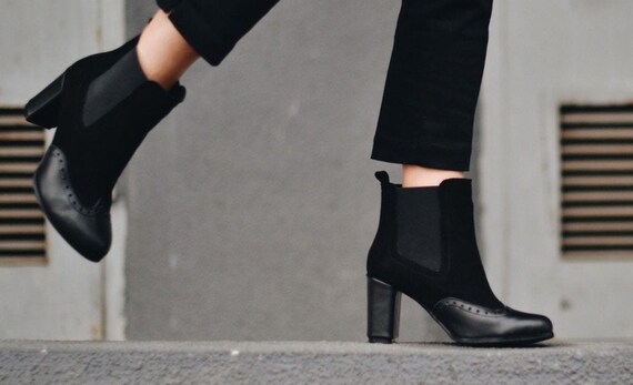 black chelsea boots on feet