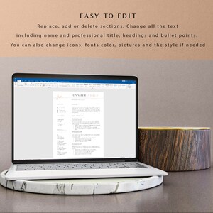 May include: A laptop computer displaying a resume template with the text "JENNEER URLE" at the top. The resume template is designed with a minimalist aesthetic and features a subtle heart rate line graphic.