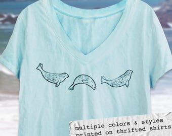 Camisetas recicladas con estampado de bloques de focas nadando