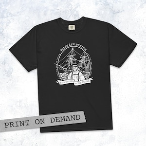 May include: Black t-shirt with a white graphic of a skeleton in a sailor's uniform in front of a ship. The words "POLAR EXPLORATION" and "MAKE HISTORY OR DIE TRYING" are printed on the shirt. The words "PRINT ON DEMAND" are printed on a gray banner.