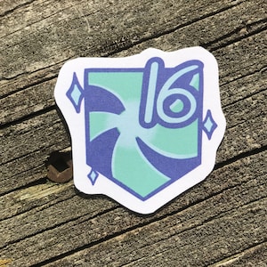 May include: A teal blue and purple sticker with a swirl design and the number 16 in the centre. The sticker has two white diamond shapes on either side of the number.