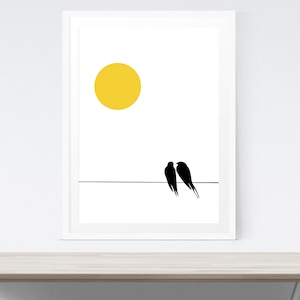 May include: A framed art print with a minimalist design. It features a yellow sun and two black birds on a black line against a white backdrop. The artwork is in a white frame, offering a clean, modern look. Ideal for home decor, the print has a simple, elegant style.