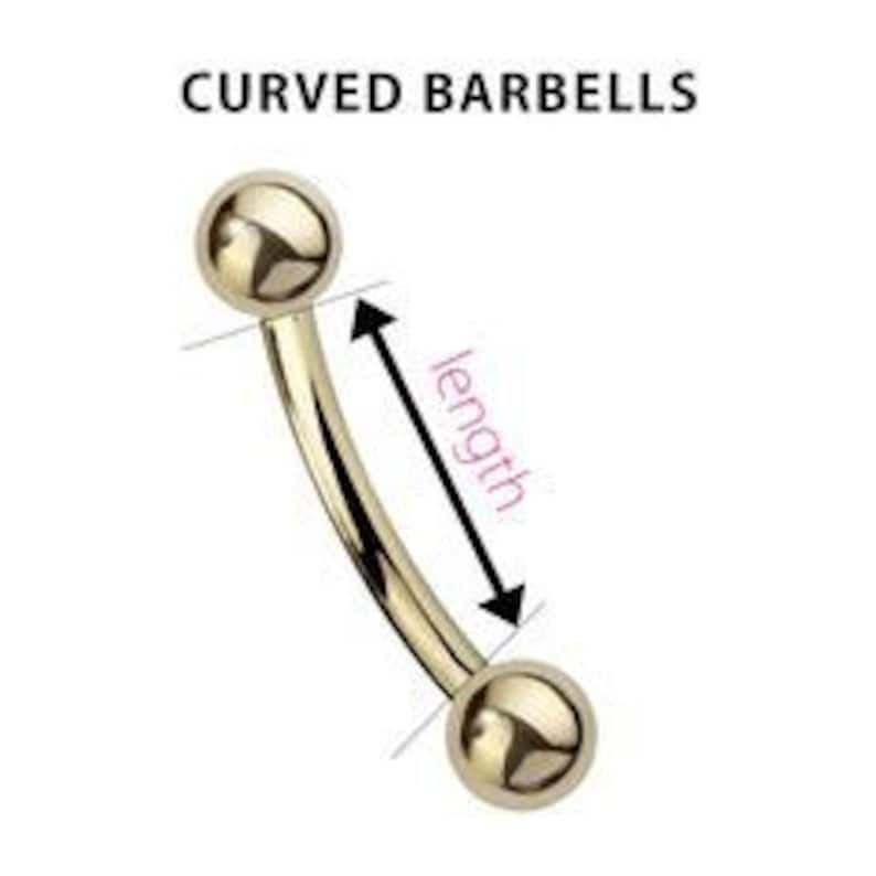 May include: Gold curved barbell with two round balls on each end. The barbell is curved and the length is measured from the center of one ball to the center of the other ball.