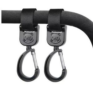 May include: Two black stroller hooks with a bear design, attached to a black bar. Each hook features a carabiner clip for securing bags or items. The hooks are made of durable materials.