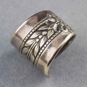 May include: A silver ring made from a repurposed spoon with a floral design.