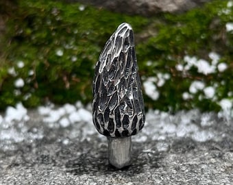 May include: A silver-colored, detailed, textured, mushroom-shaped pendant.