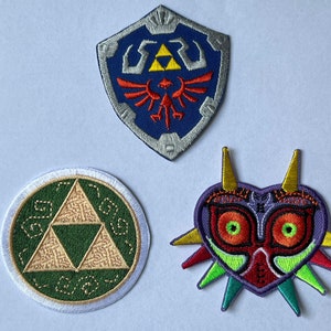 3 x Zelda-tygmärkesset, Majoras mask, komplett Triforce och Master Shield Legend of Zelda broderade applikationer stryk-på/sy-på-tygmärken