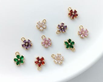 May include: Assortment of gold flower charms with colorful crystal accents. The charms feature a variety of colors including red, green, purple, and pink.