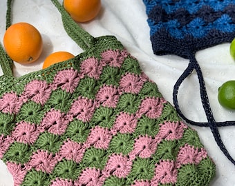 May include: Two crocheted tote bags, one in green and pink and the other in blue. Both bags have a checkered pattern.