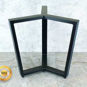 May include: Black metal table base with a triangular shape and three legs. The base is made of sturdy metal and has a black finish.