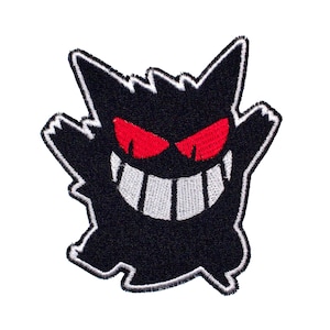 May include: Black and white embroidered patch of a cartoon ghost with red eyes and a wide, toothy grin.