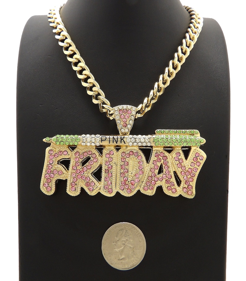 May include: Gold chain necklace with a large pendant that says "PINK FRIDAY" in gold letters with pink and green rhinestones.