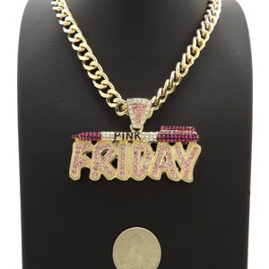 May include: Gold chain necklace with a large pendant that says "PINK FRIDAY" in gold letters with pink rhinestones.