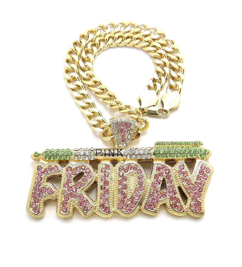 May include: Gold chain necklace with a large pendant that says "FRIDAY" in gold letters with pink and green rhinestones. The pendant also has the word "PINK" in smaller letters.