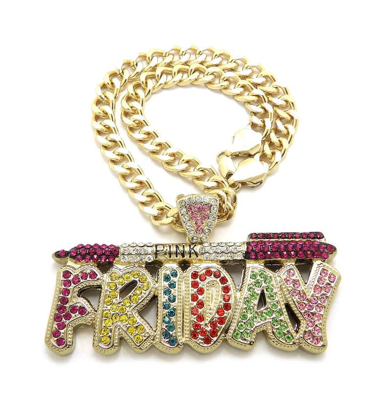 May include: Gold chain necklace with a pendant that says "FRIDAY" in colourful rhinestones. The pendant also features a pink lipstick with rhinestones.
