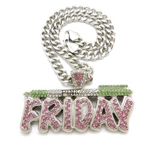 May include: A silver chain necklace with a large pendant that says "PINK FRIDAY" in pink and green rhinestones.