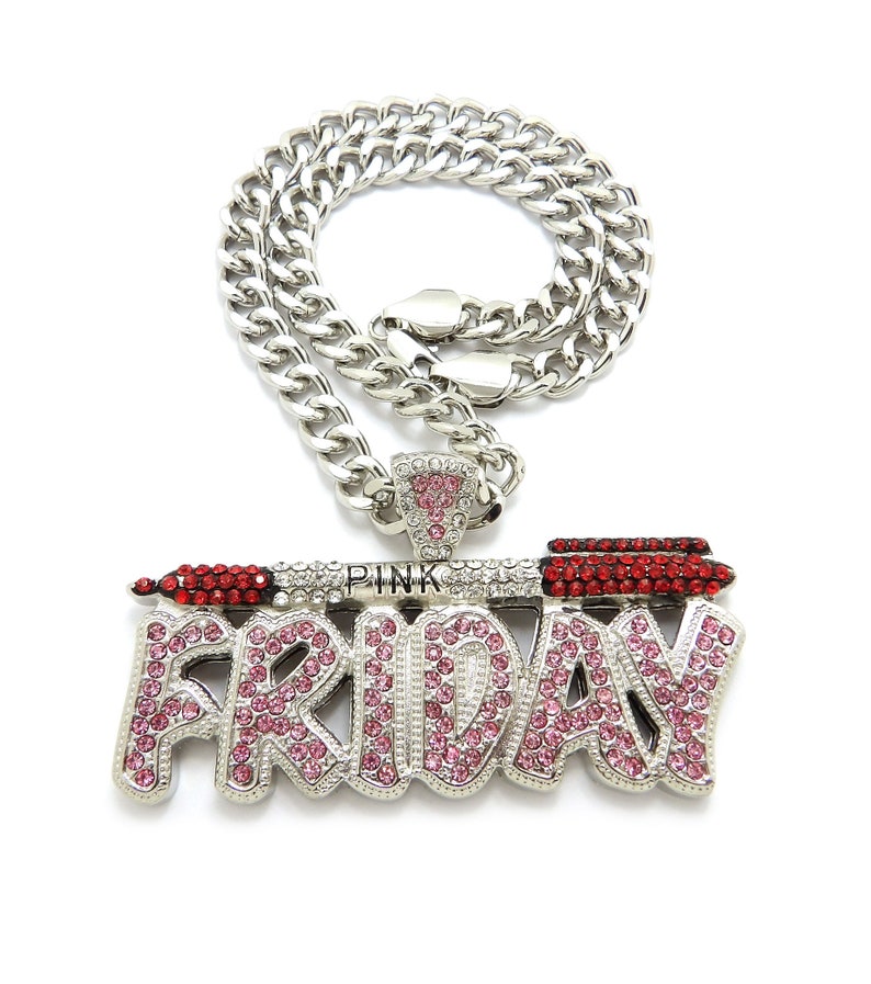May include: Silver chain necklace with a large pendant featuring the word "FRIDAY" in pink and red rhinestones. The pendant also includes a small lipstick design with the word "PINK" above it.