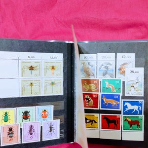Album with antique postal stamps MNH