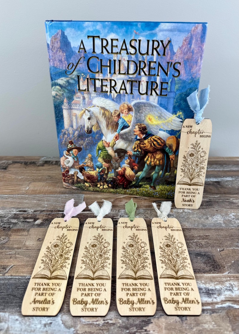 May include: A Treasury of Children's Literature book with a colorful illustration and several wooden bookmarks. The bookmarks have floral designs and the text "A New Chapter Begins" and "Thank You For Being A Part Of" with names.