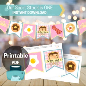 Puede incluir: Una guirnalda rosa y azul con ilustraciones de desayuno, incluyendo panqueques, huevos, tocino y gofres. La pancarta dice "Our Short Stack is ONE" y "Instant Download". También se incluye un PDF imprimible.
