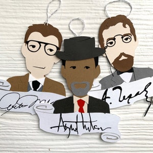May include: Three paper ornaments featuring illustrations of men's faces with their names written below. The ornaments are decorated with a red, white, and blue color scheme. The names are "Otto Marx", "August Hilton", and "A. Zeigler".