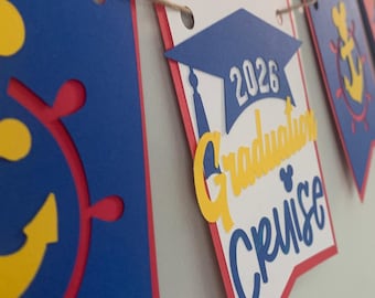 Pancarta de papel para el crucero de graduación de 2026 en rojo, amarillo y azul.