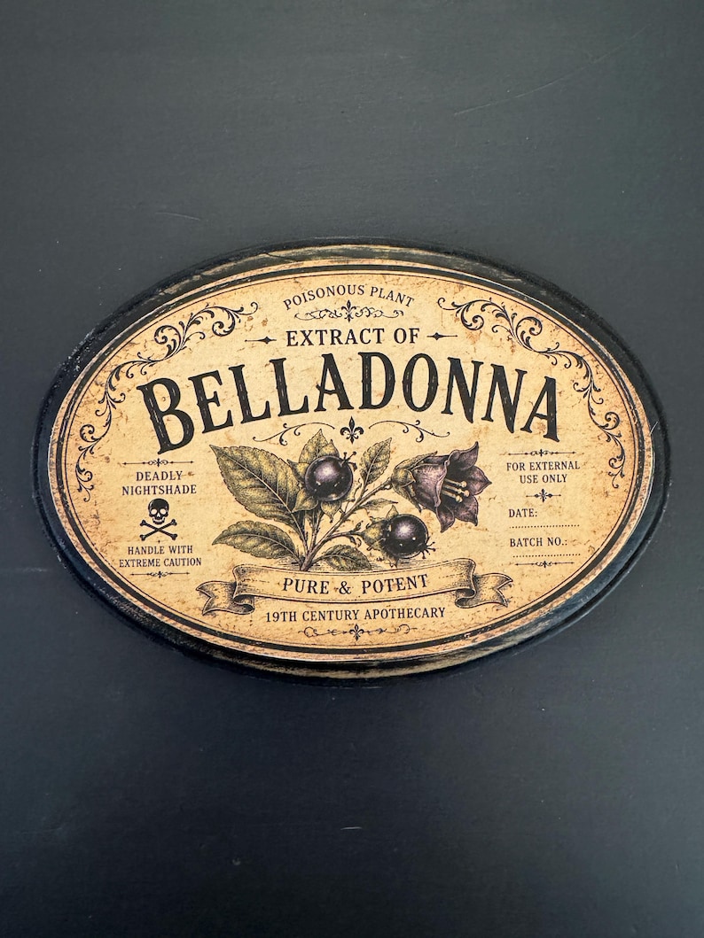 May include: An oval-shaped sign with a distressed beige background and black border. The text reads: POISONOUS PLANT EXTRACT OF BELLADONNA, DEADLY NIGHTSHADE, FOR EXTERNAL USE ONLY, PURE & POTENT, 19TH CENTURY APOTHECARY. It features a skull icon and botanical illustrations.