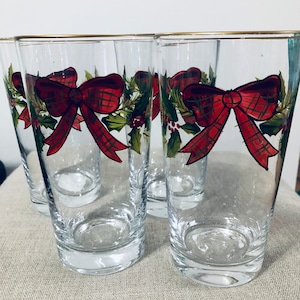 Vintage Four Lovely Hand-painted Christmas Glasses. 6 1/2 inches tall. Gold trim. Adorned with red Christmas bows and greenery.  Lovely.