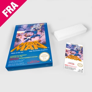 May include: A blue and white Nintendo Entertainment System game cartridge for Mega Man. The front of the cartridge features a colourful illustration of Mega Man in action. The text "Mega Man" is printed in white on a blue background. The text "Game Pak by CAPCOM" is printed in white on a blue background. The text "Licensed by Nintendo for play on the Nintendo Entertainment System" is printed in white on a blue background. The text "Original Nintendo Seal of Quality" is printed in white on a red circle.