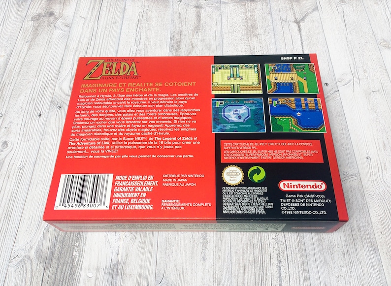 May include: Red and black video game box for The Legend of Zelda: A Link to the Past for the Super Nintendo Entertainment System. The box features a barcode, game screenshots, and text in French.