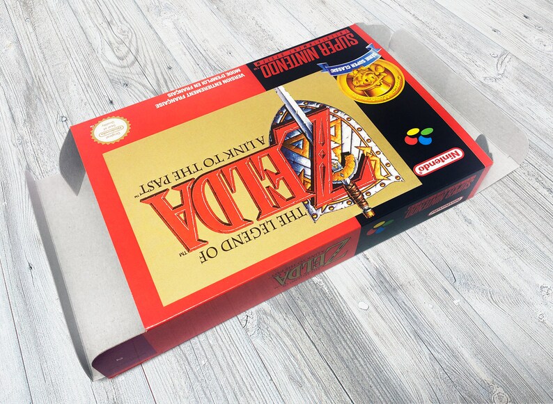 May include: A red and gold Super Nintendo game cartridge for The Legend of Zelda: A Link to the Past. The game cartridge has a picture of Link holding a sword and shield.