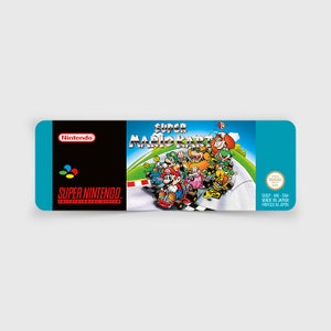 May include: A blue and black Super Nintendo game cartridge label featuring the text "Super Mario Kart" and a colourful illustration of Mario and other characters racing on a track.
