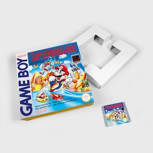 May include: A blue and yellow Game Boy cartridge case featuring a picture of Mario on the front. The case has the text "Super Mario Land" and "Game Boy" on it. The case is in good condition and shows no signs of damage.