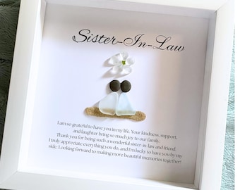 Könnte beinhalten: Ein weiß gerahmtes Bild mit einer weißen Blume und einer Kunst aus Meerglas. Der Text lautet "Sister-In-Law" und enthält eine Botschaft der Dankbarkeit und Wertschätzung.